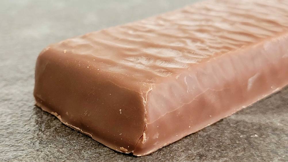 Im Test: Nahaufnahme eines ausgepackten Proteinriegels einer Ecke.