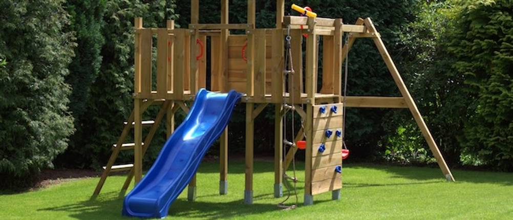 Wickey-Spielturm im Test: Ein Spielturm aus Holz mit einer blauen Rutsche auf einer Grünfläche.