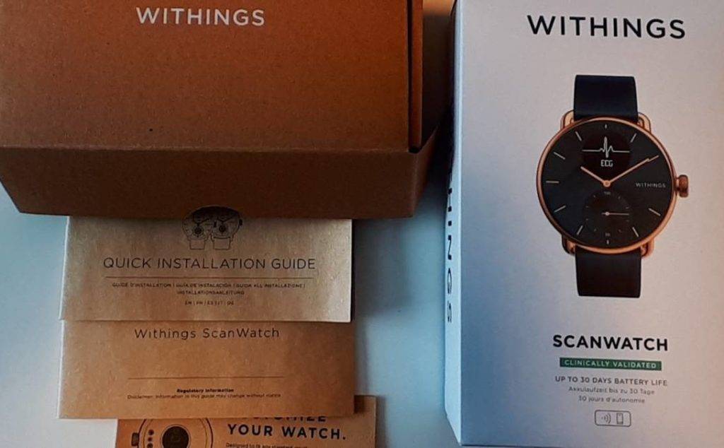 EKG-Uhr getestet: Nahaufnahme der Withings-Scanwatch-Verpackung neben dazugehörigen Zertifikaten und Installationsanleitung auf Englisch.