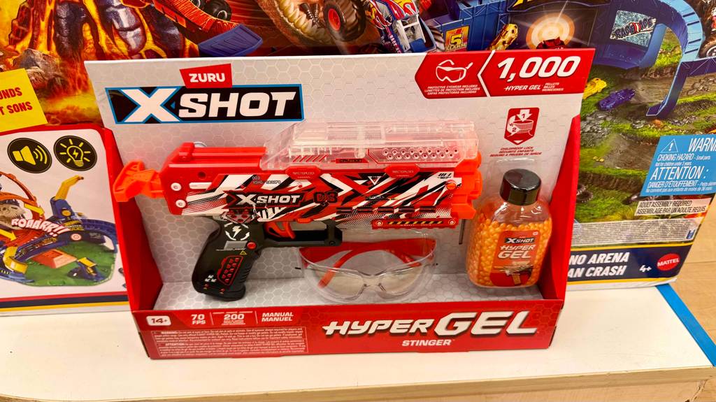 Gel-Ball-Blaster getestet: Das Set, bestehend aus der Pistole, der Sicherheitsbrille und den Gel-Kugeln, steht in seiner Verpackung auf einem Ausstellungsregal im Geschäft.