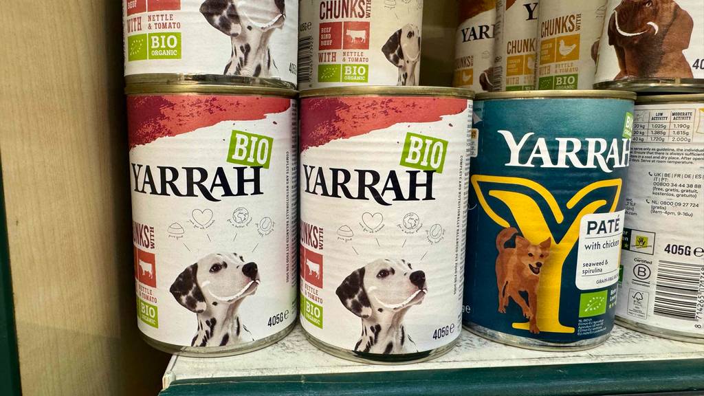 Das getestete Bio-Nassfutter für Hunde steht in einer 405-g-Dose in einem mit Dosen gefüllten Verkaufsregal.