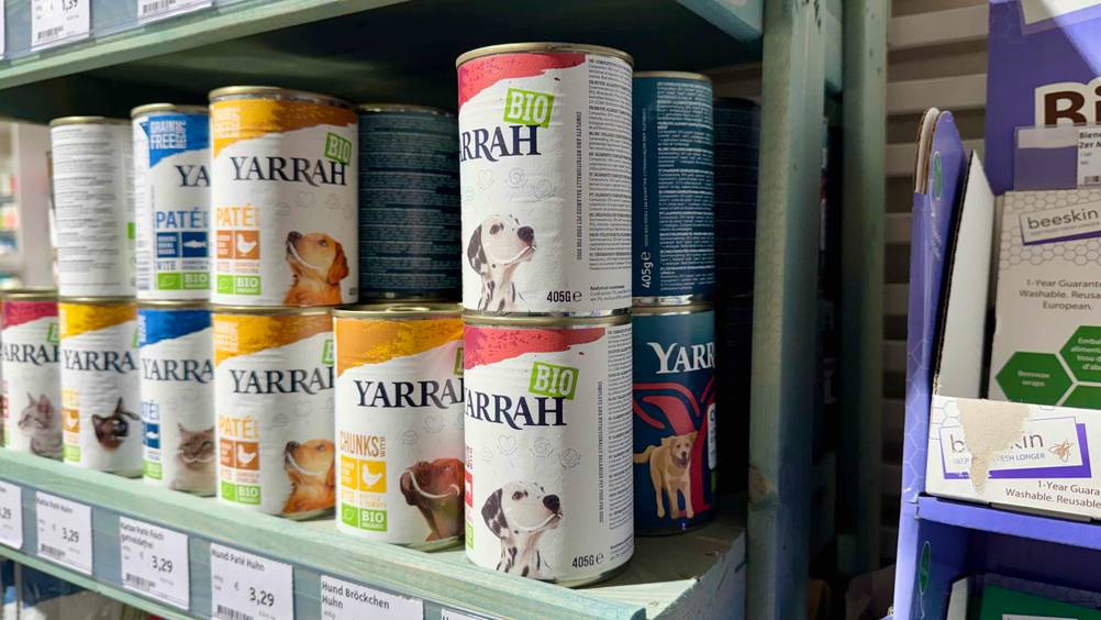 Mehrere Dosen Yarrah-Hundefutter im Test von der Seite in einem Regal.
