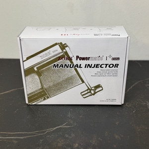 Verpackung der getesteten Zigarettenstopfmaschine von Powermatic auf einer Arbeitsfläche.