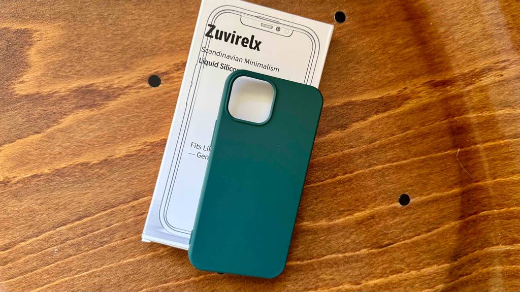 Blick von oben auf eine getestete iPhone-13-mini-Hülle, die auf einer Holzfläche liegt.