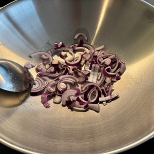 Zwiebeln werden in dem Zwilling-Plus-Wok angebraten