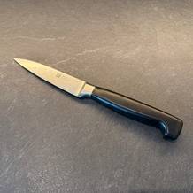 Das Zwilling-Vier-Sterne-Spick- und Garniermesser liegt auf einer Küchenarbeitsplatte